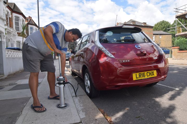 Ο οδηγός της Uber, Tim Win συνδέει το ηλεκτρικό Nissan Leaf του σε ένα σύστημα φόρτισης ηλεκτρικών οχημάτων στο δρόμο που αναπτύχθηκε από την startup Trojan Energy στο Λονδίνο, Βρετανία, 2 Αυγούστου 2021. Εικόνα που λήφθηκε στις 2 Αυγούστου 2021. REUTERS/Nick Carey