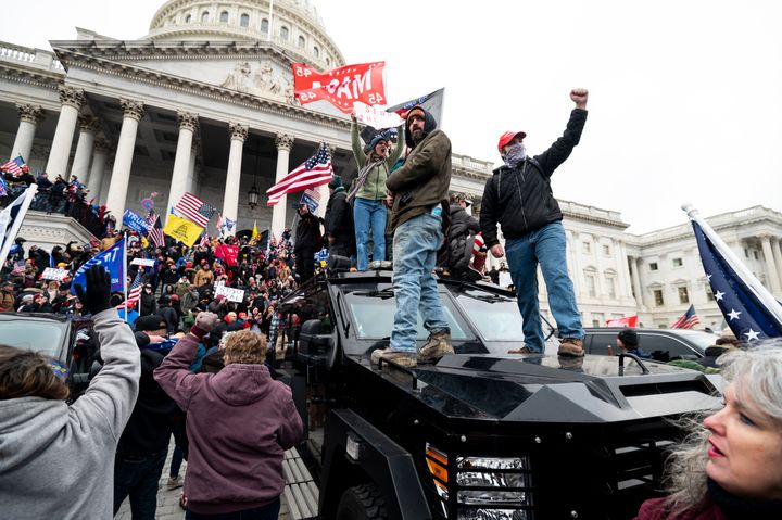 Supporters of Donald Trump stand on a U.S. Capitol Police armored vehicle as others take over the steps of the Capitol on Jan. 6.