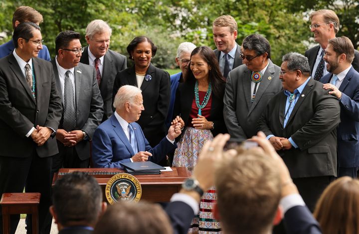 President Joe Biden hands a pen to Secretary of the Interior Deb Haaland after signing an executive order to expand the areas of three national monuments during an event at the White House on Oct. 8, 2021. The Biden administration restored the areas of two Utah sites held sacred by several Native American tribes after former President Donald Trump opened them to mining, drilling and development during his time in office.