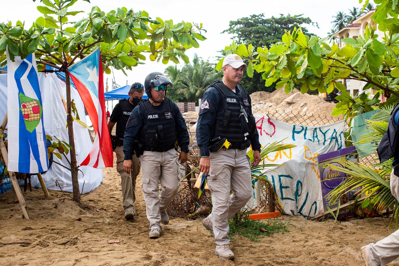 Police change shifts as they stand guard at the construction site.