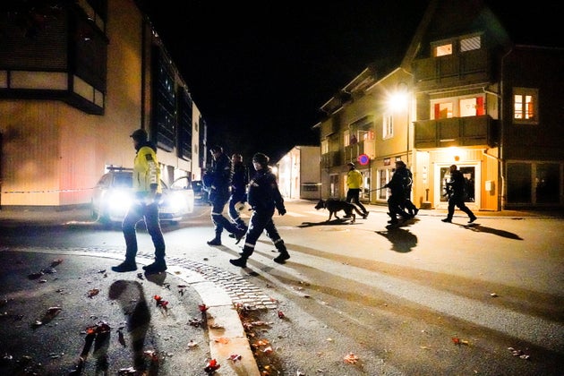 Police officers investigate after several people were killed and others were injured by a man using a...