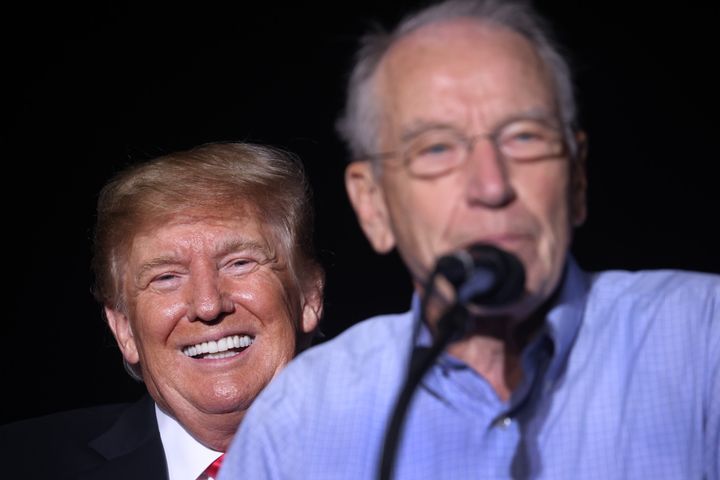 Former President Donald Trump smiles as Sen. Chuck Grassley (R-Iowa) speaks during a rally at the Iowa State Fairgrounds on Oct. 9 in Des Moines. Trump endorsed Grassley for reelection at the event.