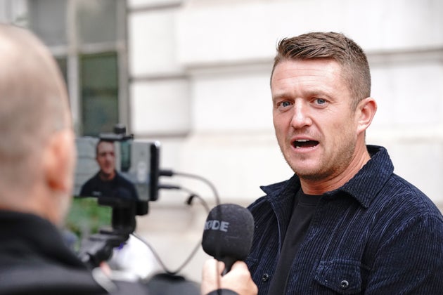 Tommy Robinson arrives at Westminster Magistrates' Court in London for a hearing regarding the stalking...