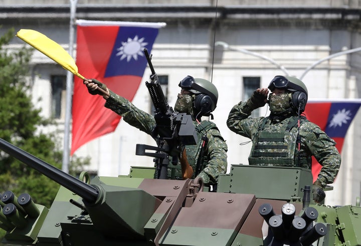 Taiwanese soldiers salute during National Day celebrations in front of the Presidential Building in Taipei, Taiwan, Sunday, Oct. 10, 2021. (AP Photo/Chiang Ying-ying)