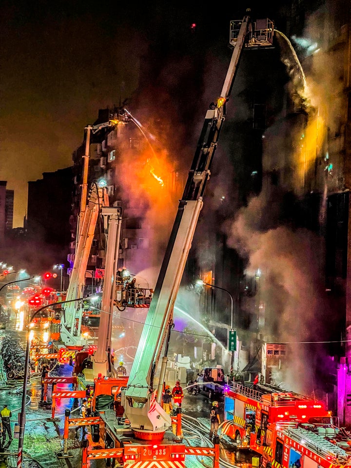 Firefighters battle a building fire in Kaohsiung, southern Taiwan, on Oct. 14, 2021.