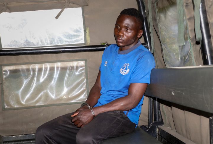Murder suspect Masten Wanjala sits in the back of a police truck after being taken by police to a scene to identify the location of alleged victim remains, on the outskirts of Nairobi, Kenya Wednesday, July 14, 2021. Police in Kenya said Friday, Oct. 15, 2021 that the man who police say confessed to killing a dozen children and escaped from detention this week has been killed by a mob near his home in Bungoma county. (AP Photo)