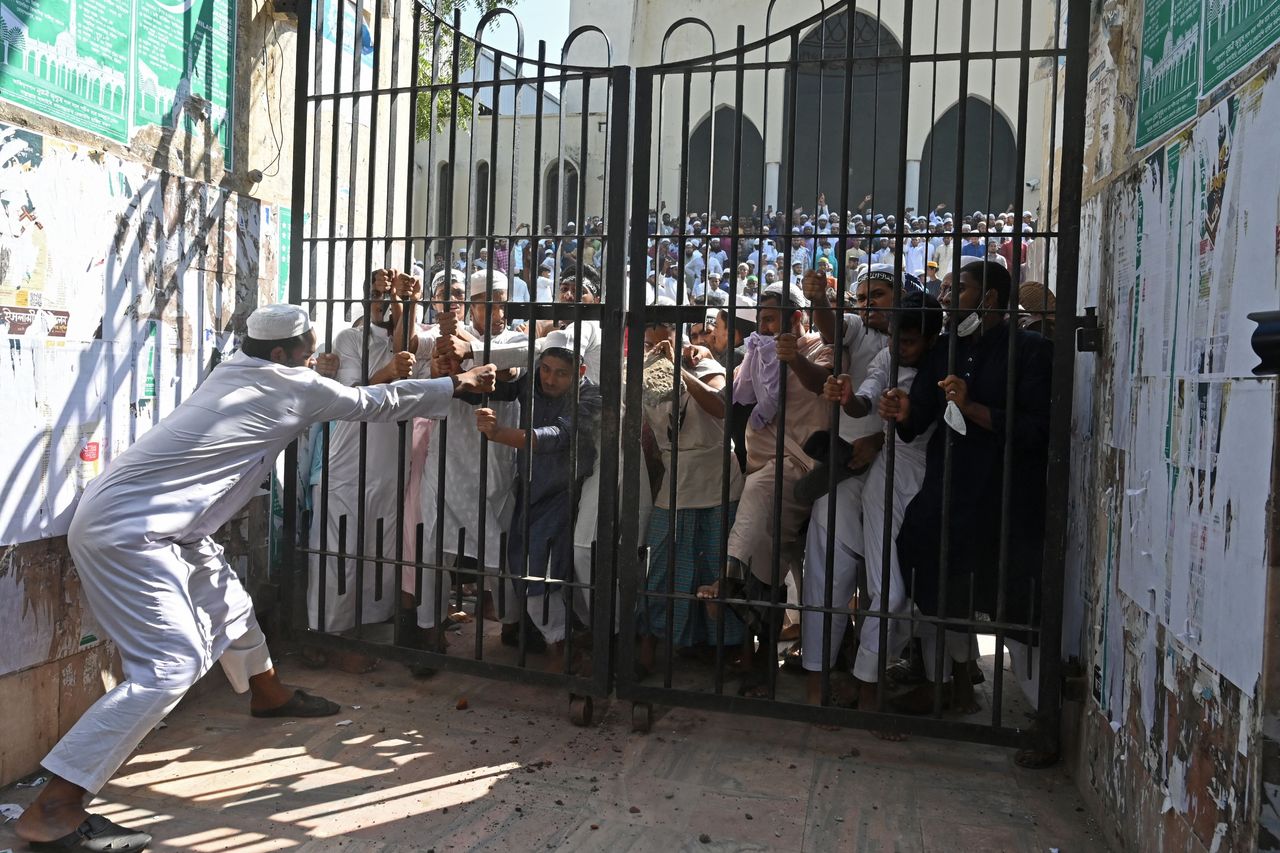 Protesters try to break a locked gate of the National Mosque during a demonstration after the Friday prayers in Dhaka, Bangladesh, on Oct. 15. The protests began after footage emerged of a Koran being placed on the knee of a figure of a Hindu god during celebrations for the Hindu festival of Durga Puja.