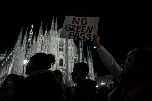 People protest against the so-called Green Pass on Piazza Duomo in Milan on October 16, 2021 as all workers...