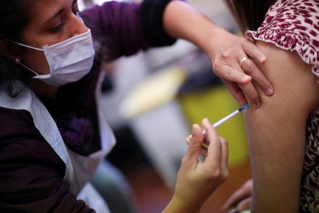 A health worker administers a dose of the Covid-19 booster vaccine in