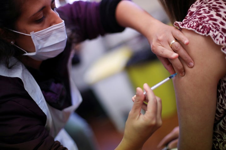 A health worker administers a dose of the Covid-19 booster vaccine in Derby.