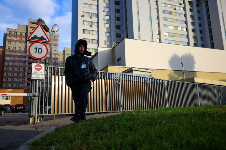 A security guard patrols outside a building that houses the NATO information office in Moscow on Oct.18, 2021. 