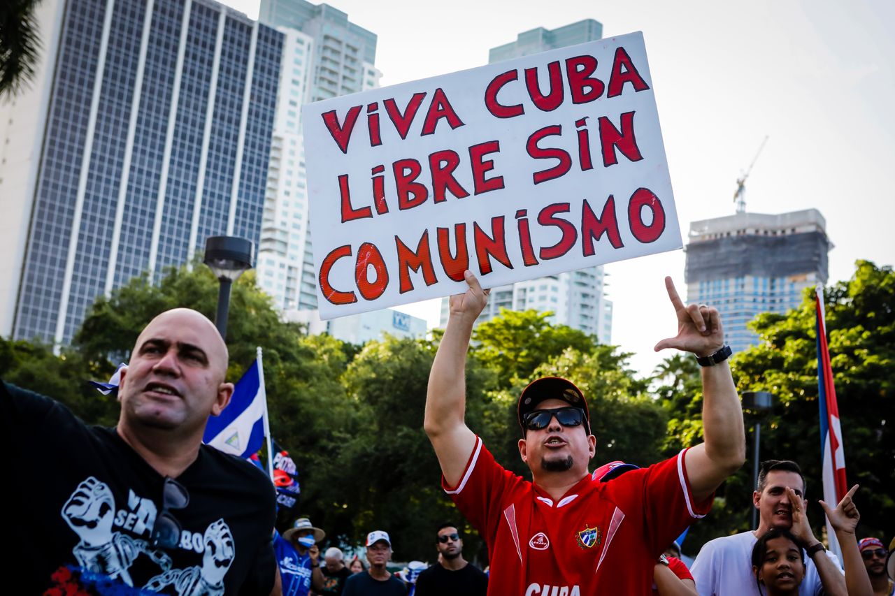 A man holds a sign that reads "Viva Cuba libre without communism" as he shouts slogans during a rally calling for freedom in Cuba, Venezuela and Nicaragua in Miami, Florida, on July 31, 2021.