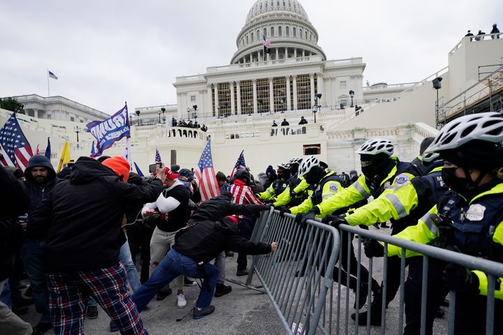 In this Jan. 6, 2021 file photo, Trump supporters try to break through a police barrier at the Capitol in Washington. (AP Photo/Julio Cortez)