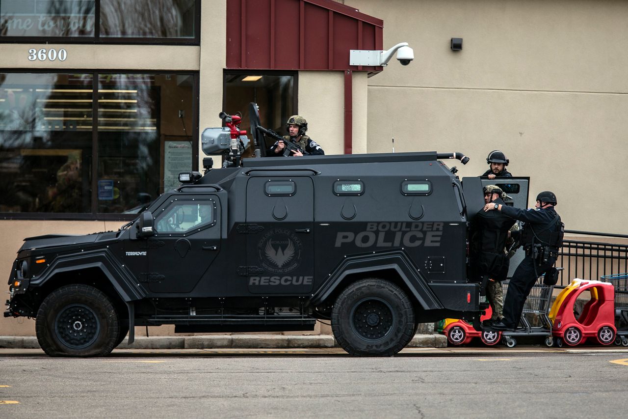 SWAT teams advance through a parking lot as a gunman opened fire at a King Sooper's grocery store on March 22, 2021 in Boulder, Colorado. Ten people, including a police officer, were killed in the attack. 