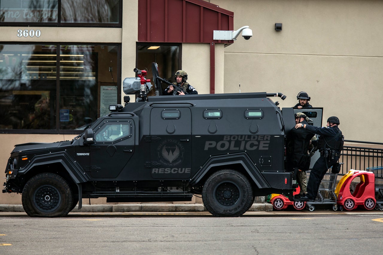 SWAT teams advance through a parking lot as a gunman opened fire at a King Sooper's grocery store on March 22, 2021 in Boulder, Colorado. Ten people, including a police officer, were killed in the attack.