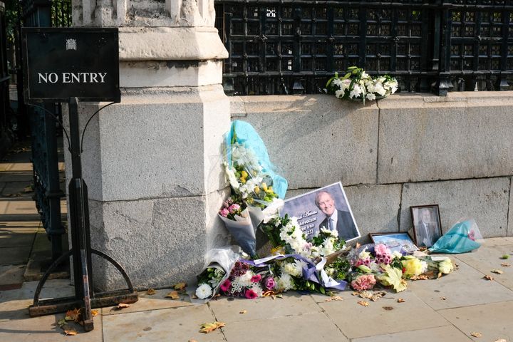 Floral tributes for Sir David Amess, outside the entrance to the Houses of Parliament.