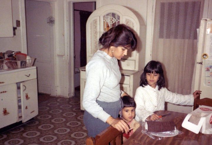 The author with her mom and younger brother as they prepared to cut a birthday cake in their haunted kitchen.
