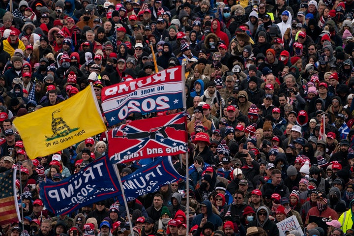 Trump supporters listen as then-President Donald Trump speaks during a rally protesting the Electoral College certification of Joe Biden's victory on Jan. 6, 2021.