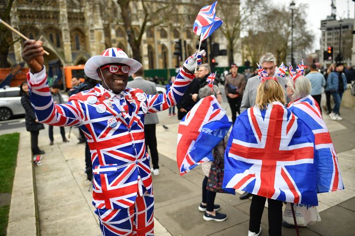 A man poses in a Union Jack suit at Parliament Square as people prepare for Brexit on January 31, 2020 in London
