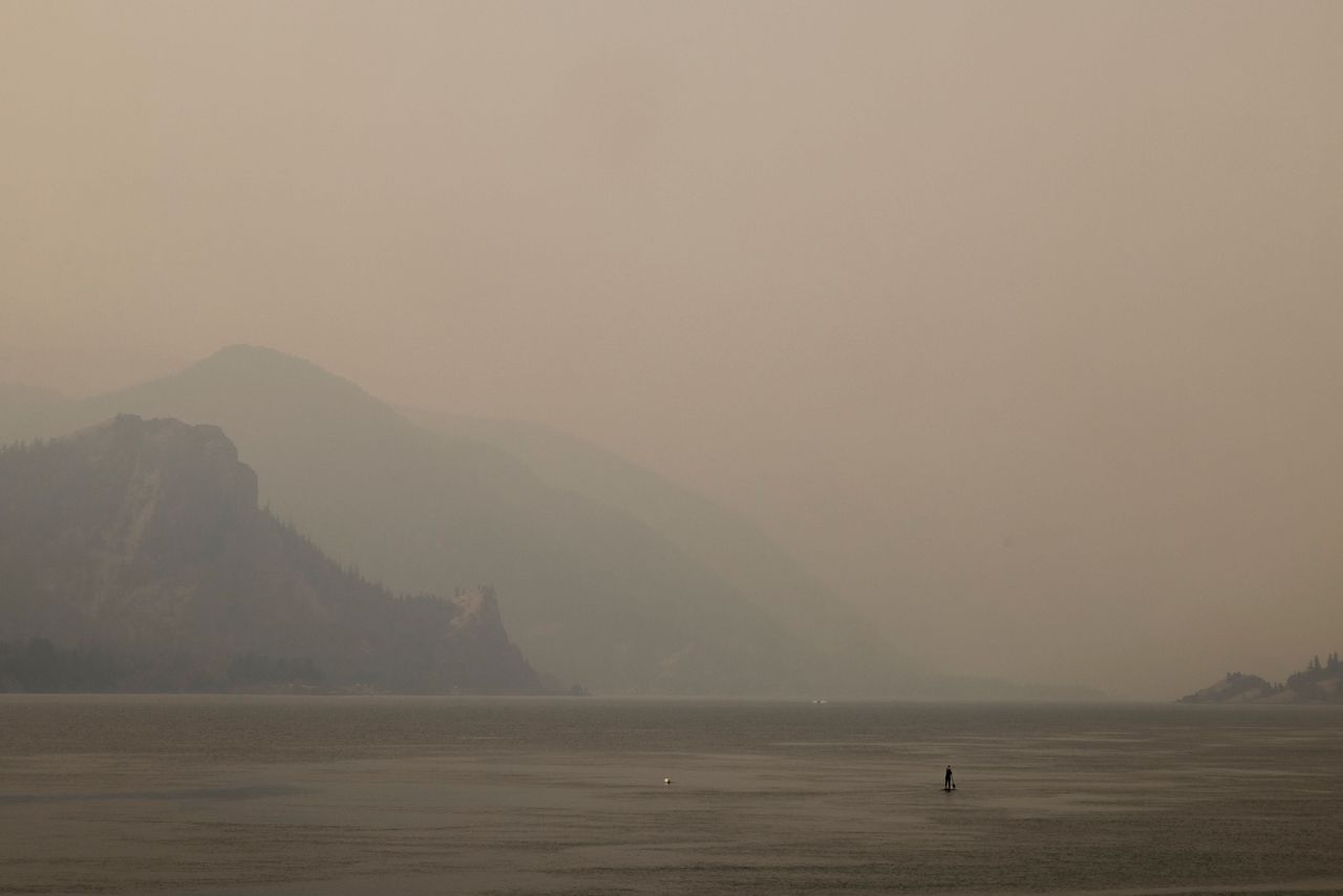 A lone paddleboarder on the Columbia River in Oregon during an abnormal heat wave in the Pacific Northwest on Aug. 13.