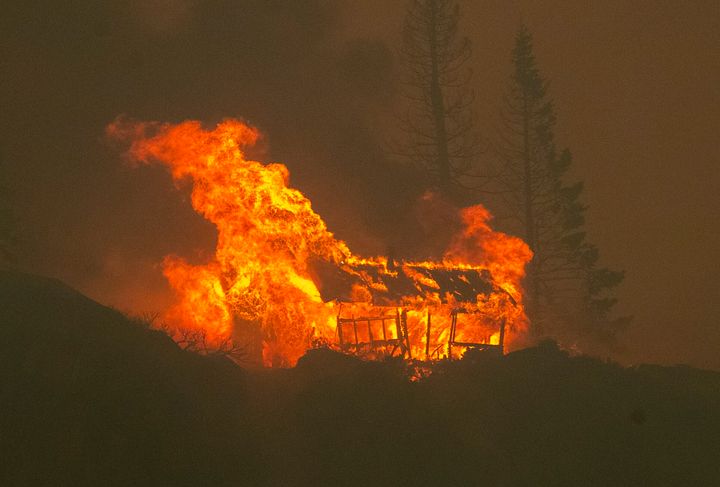 In Meyers, California, a structure is seen up in flames as the Caldor fire descends into the Tahoe Basin on Aug. 30.