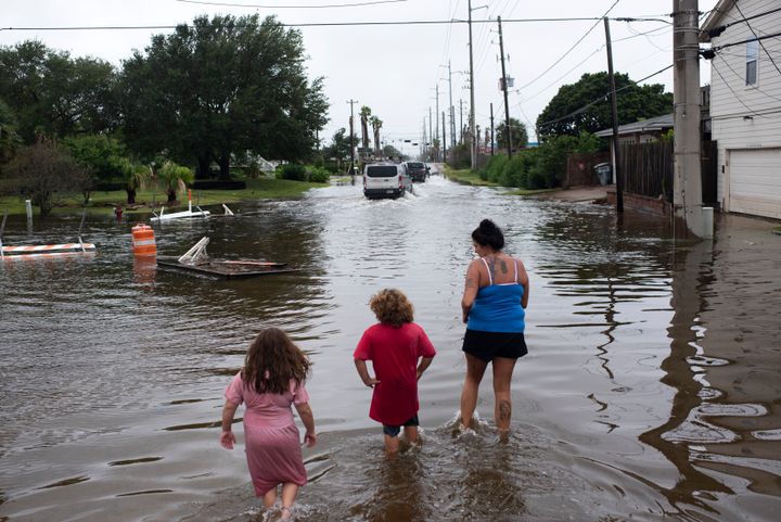 Zailey Segura, Zavery Segura and their mother, Karen Smith, wade through flood waters while walking to the children's father's house after Hurricane Nicholas landed in Galveston, Texas, in September. 