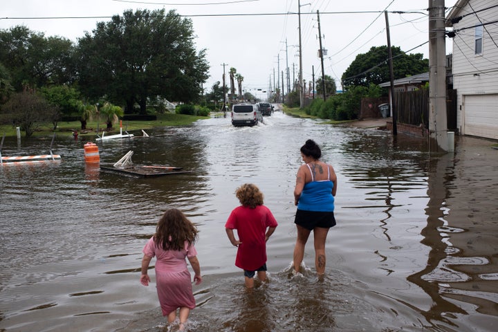 Zailey Segura, Zavery Segura and their mother, Karen Smith, wade through flood waters while walking to the children's father's house after Hurricane Nicholas landed in Galveston, Texas, in September.