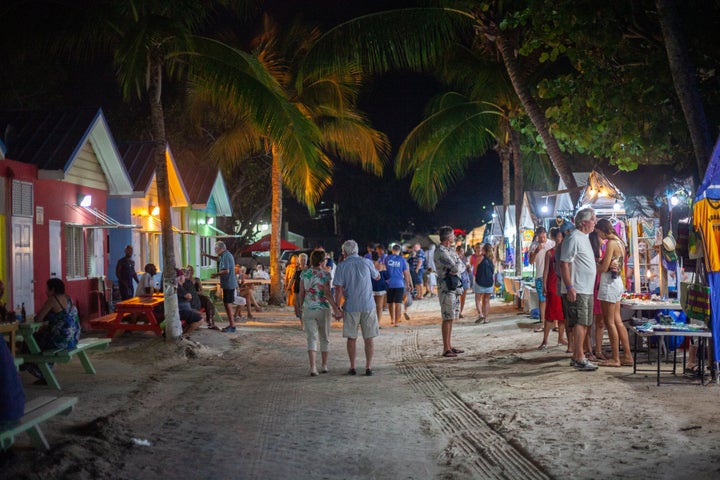 People Walking and enjoying the shopping at vendors that are set up on a Friday Night at Oistins in Barbados