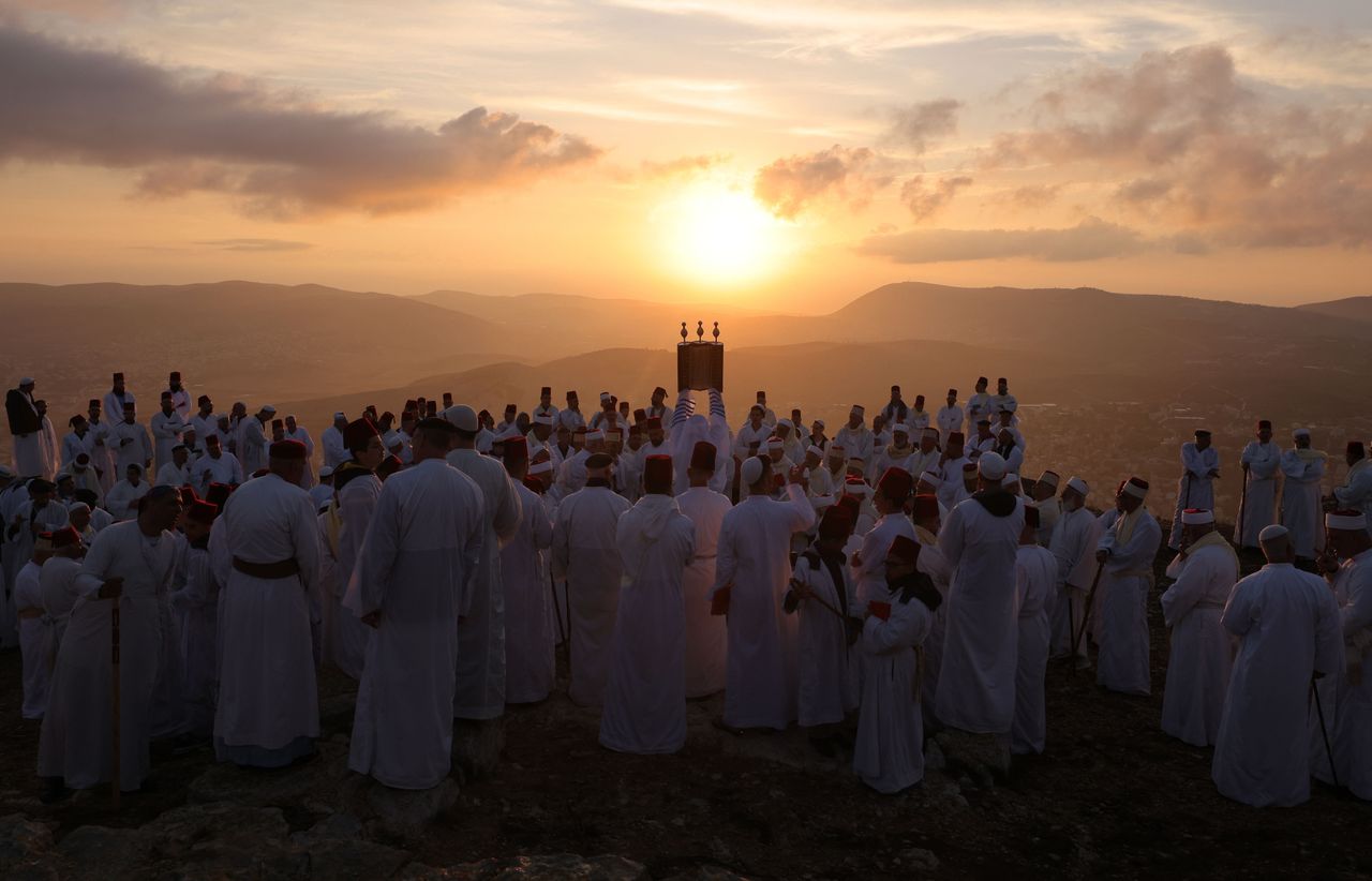 Samaritan worshippers hold a Torah scroll during a traditional pilgrimage marking the holiday of Sukkot, or Feast of Tabernacles, on top of Mount Gerizim, near the northern city of Nablus in the Israeli-occupied West Bank, on Oct. 20.