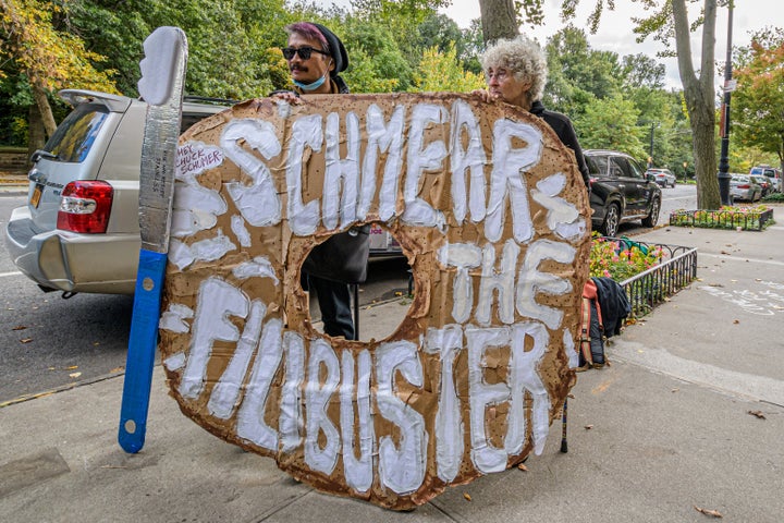 Anti-filibuster activists pressure Senate Majority Leader Chuck Schumer (D-N.Y.) to change the Senate rule at a protest in New York City.