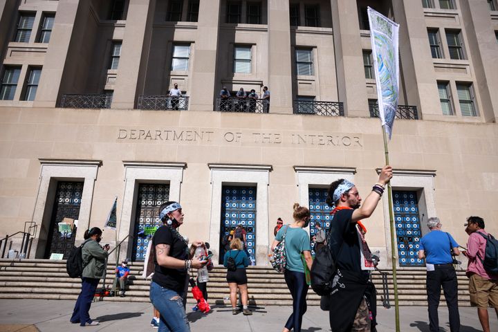 Protesters rally outside the Department of Interior as climate activists hold a sit-in inside the agency's headquarters on Oct. 14.