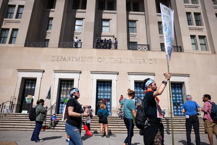 Protesters rally outside the Department of Interior as climate activists hold a sit-in inside the agency's headquarters on Oct. 14.