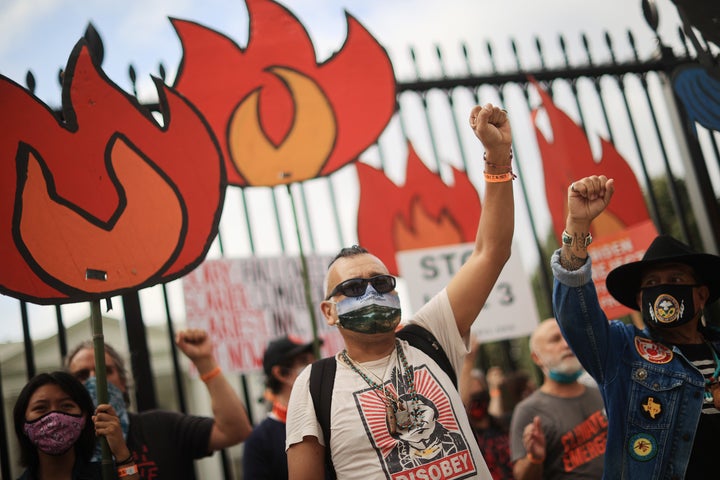 Demonstrators prepare to be arrested during a rally outside the White House as part of the "Climate Chaos Is Happening Now" protest on Oct. 13.