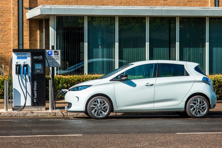 Electric car plugged into a charge point in Cambridge, England.