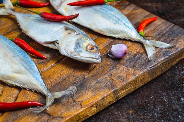 Mackerel Fish On Wooden Chopping Board