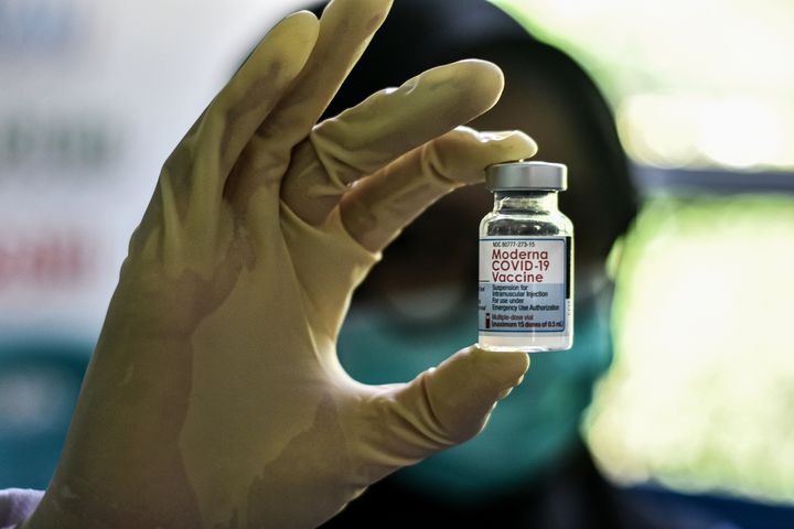 A health worker holds up a bottle of the Moderna COVID-19 vaccine. Moderna said Monday that a low dose of its COVID-19 vaccine is safe and appears to work in 6- to 11-year-olds.
