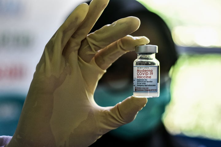 A health worker holds up a bottle of the Moderna COVID-19 vaccine. Moderna said Monday that a low dose of its COVID-19 vaccine is safe and appears to work in 6- to 11-year-olds.