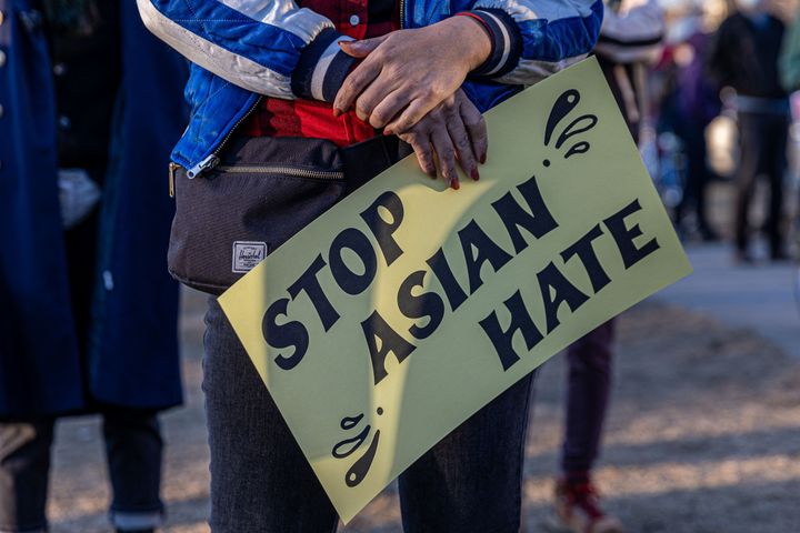 A person holds a sign during the "Asian Solidarity March" rally against anti-Asian hate in Minneapolis in March.
