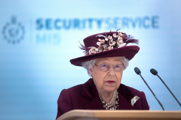 Britain's Queen Elizabeth II reacts during her visit to the headquarters of MI5, Britain's domestic security...