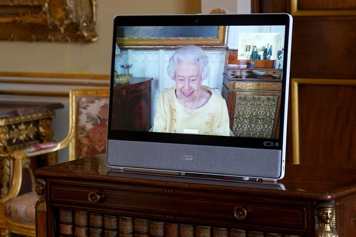 Queen Elizabeth II appears on a screen via videolink from Windsor Castle.