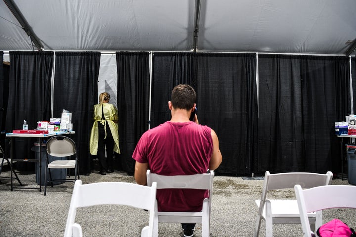 Above, a patient waits for treatment inside the Regeneron Clinic at a monoclonal antibody site in Pembroke Pines, Florida.