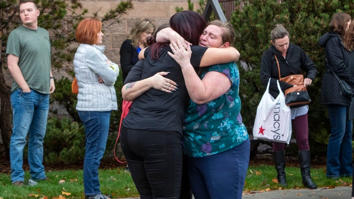 People evacuated from the Boise Towne Square shopping mall await news after a man opened fire in the mall Monday, Oct. 25, 2021, in Boise, Idaho. (Darin Oswald/Idaho Statesman via AP)