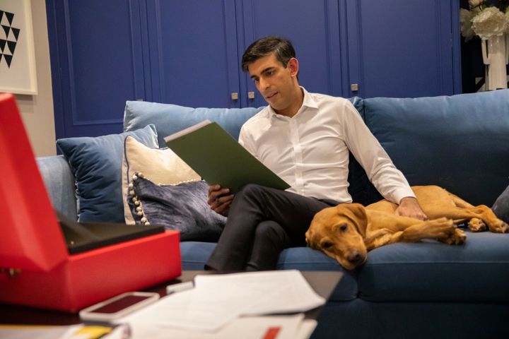 Chancellor Rishi Sunak, kept company by his red Labrador retriever puppy Nova, works on his budget speech in his flat in Downing Street