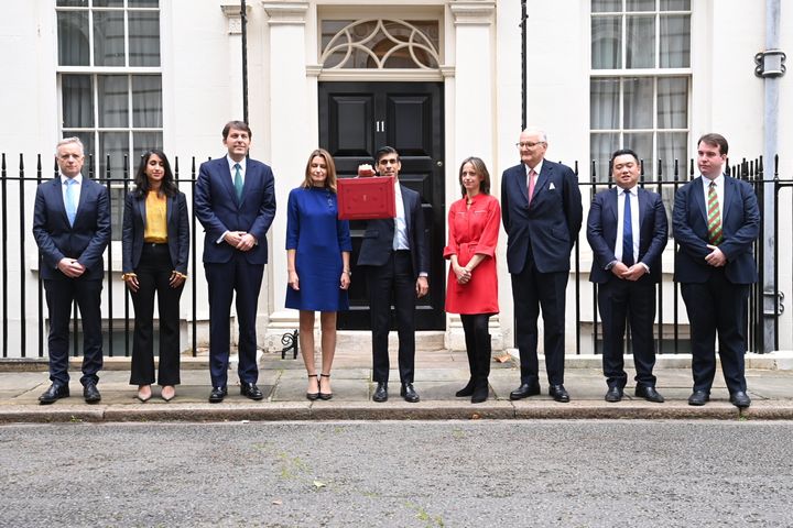 Chancellor of the exchequer Rishi Sunak holds the budget box as he stands with members of this Treasury team outside 11 Downing Street