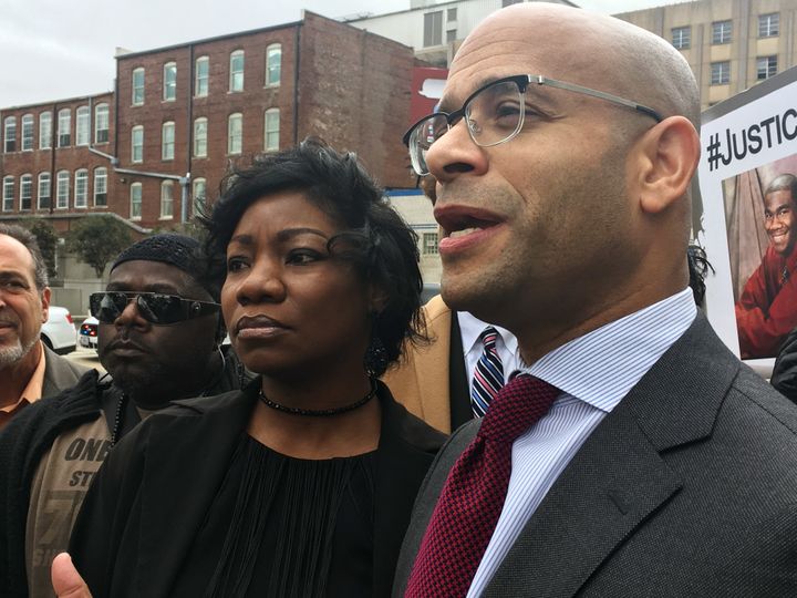 Monteria Robinson, mother of Jamarion Robinson, who was shot by police in August 2016, stands with her lawyer, Andrew M. Stroth, as he addresses reporters at a news conference outside the federal courthouse, on Jan. 10, 2018, in Atlanta.