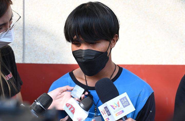 A Myanmar national identified as Song, one of two painters rescued from a high-rise condominium in Thailand, talks to reporters at Pak Kret police station in Nonthaburi near Bangkok, Wednesday, Oct. 27, 2021. A resident of the building cut the support rope for the two painters, apparently angry she wasn't told they would be doing work, and left them hanging above the 26th floor until a couple rescued them, police said Wednesday. The woman is facing charges of attempted murder, according to a police official. (AP Photo/Surat Sappakun)