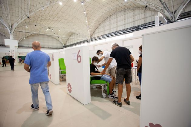 BARI, ITALY - AUGUST 07: People get vaccinated inside the hub on August 07, 2021 in Bari, Italy. The...