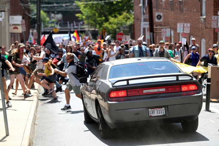 In this Aug. 12, 2017, file photo, a vehicle drives into a group of protesters demonstrating against a white nationalist rally in Charlottesville, Virginia.