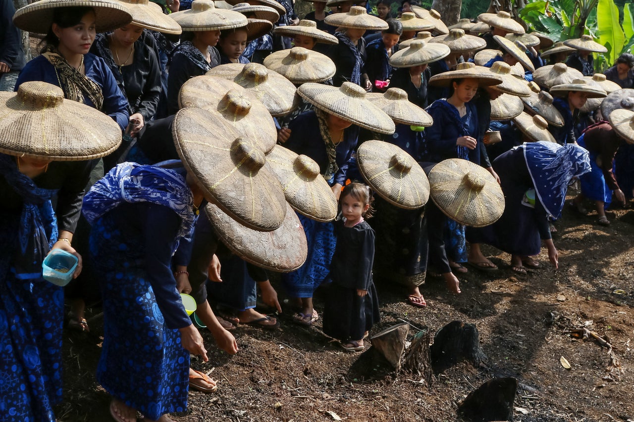 Baduy women plant rice in the fields at Ciboleger village in Banten, Indonesia, on Oct. 23.