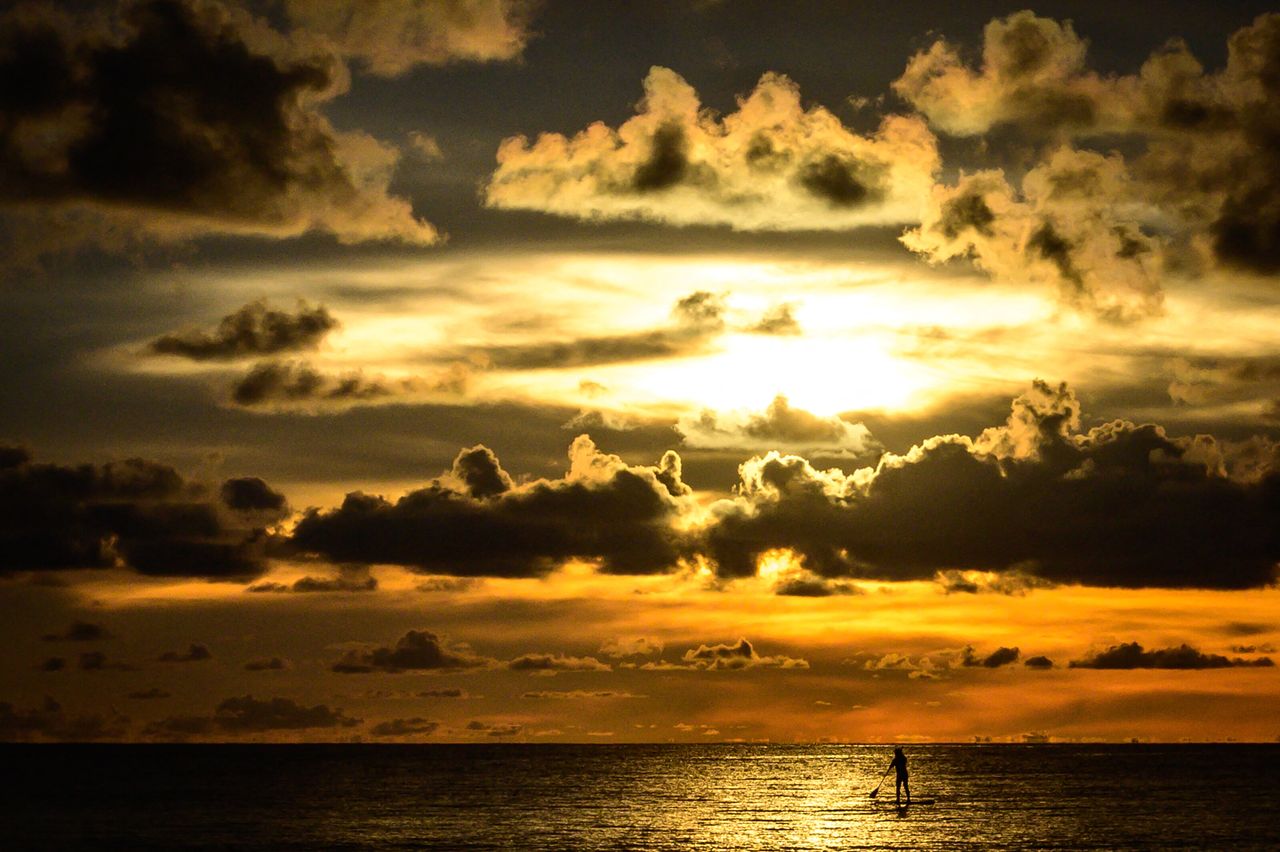 A woman paddleboards at sunset on a beach on the Thai island of Phuket as tourists take advantage of the "Phuket Sandbox" program on Oct. 24.